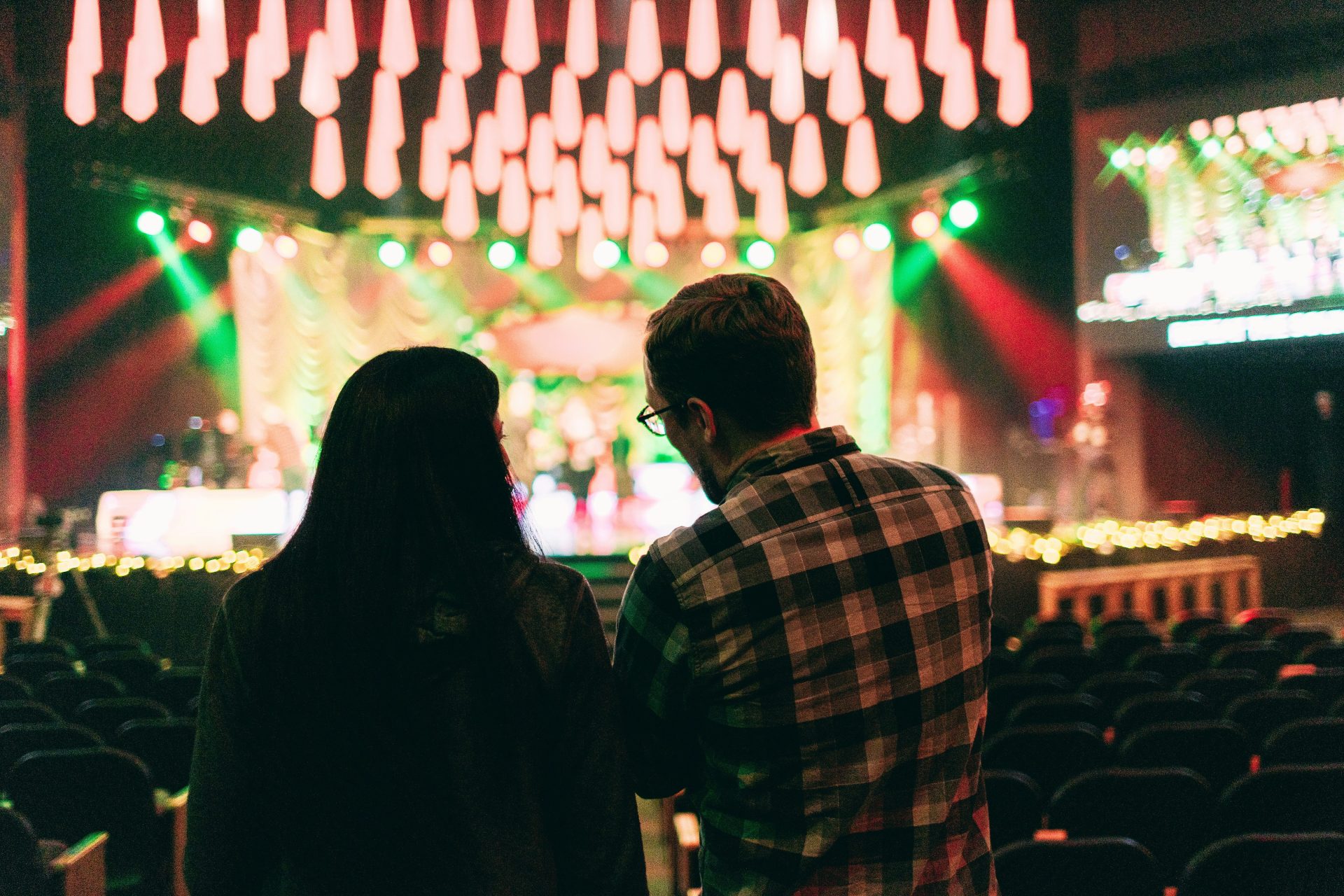 a man and a woman standing in front of a stage