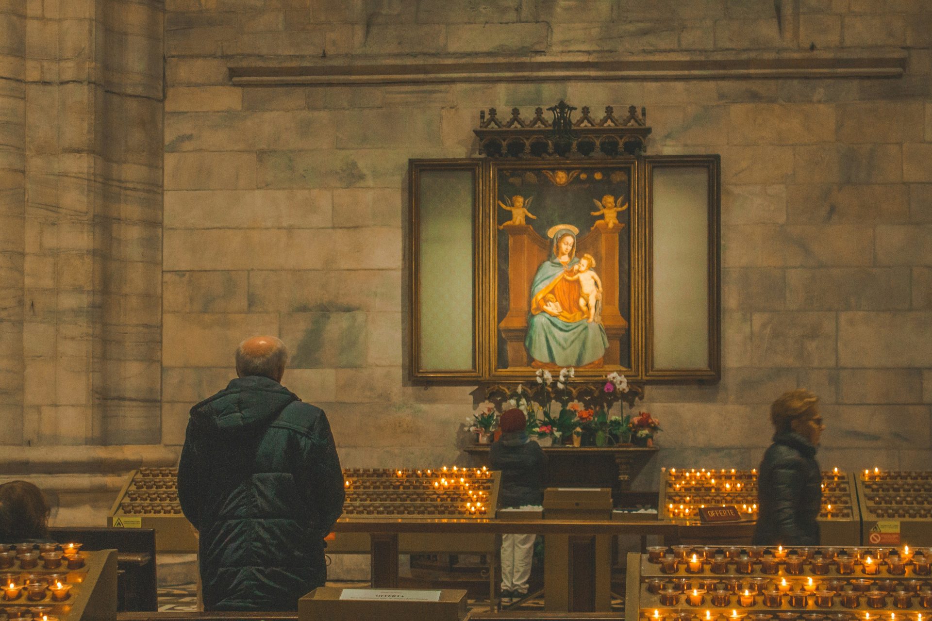 man in black coat standing in front of the church